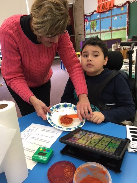 Students making holiday english muffins.